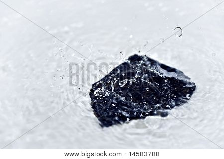 Water splashes on stone