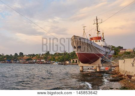 Old little fishing trawler at sunrise. The trawler parked in the dock
