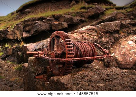 Rusted iron wheal at the coastline in the Faroe Islands