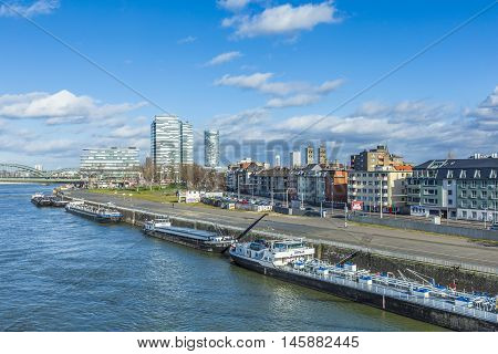 Cologne Skyline With Ships On Pier