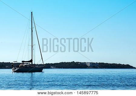 A boat on the sea with no clouds on horizon