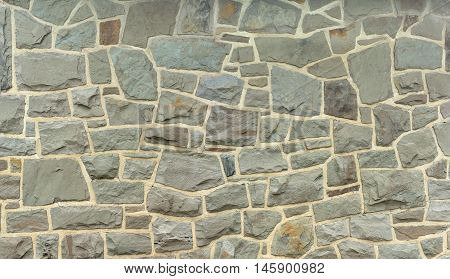 rock background stone wall of ancient fieldstone house
