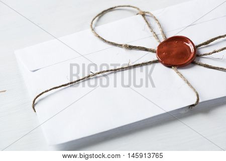 Old letter envelope with wax seal on wooden surface