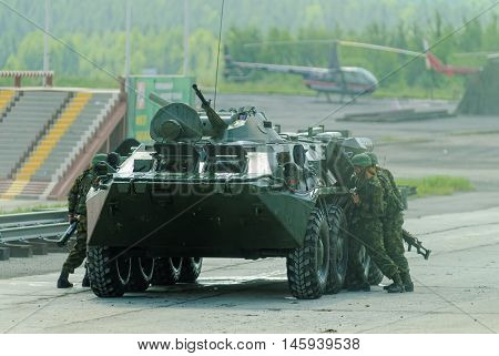 Nizhniy Tagil, Russia - July 12. 2008: Group of special forces unload from BTR-82A armoured personnel carrier on shooting demonstration range