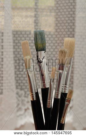 A set of paintbrushes standing on a table