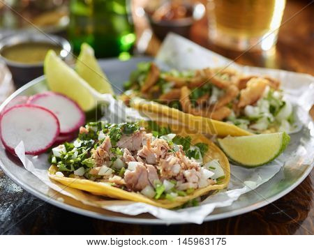 tasty tacos in yellow tortilla with chopped pork