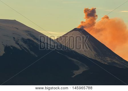 Emission ash from a volcano Klyuchevskoy dawn rays of the sun.