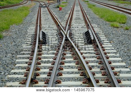 Two railways tracks merge close up.Industrial concept.