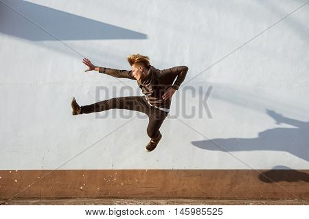Man jumps on white wall. City concept