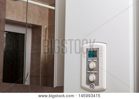 Control panel of DHW or central heating on combi boiler in restroom.