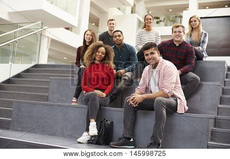 Portrait Of Student Group On Steps Of Campus Building