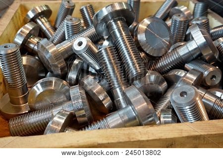 New Bolts And Screws After Turning Are In A Wooden Box.   Processing Of Metal By Cutting At A Manufa