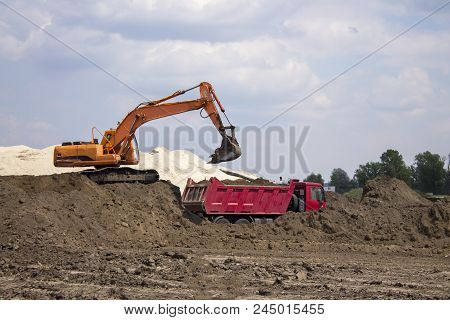 Photo Of Excavator And Dumper Truck. Construction Site Digger. Industrial Machinery On Building Site