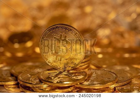 Morgantown, Wv - 13 June 2018: Macro Image Of Bitcoin Cybercurrency Coin Standing On Top Of A Stack 