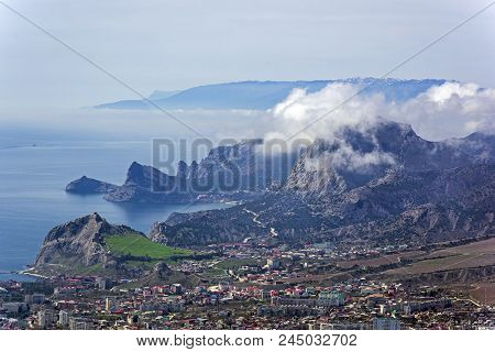 The Tops Of The Mountains Are Covered With Clouds. View From The Top Of Mount Ai-george (the Western