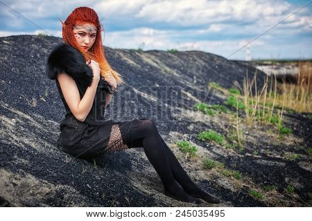 Elf Women With Fiery Hair On Nature. Beautiful Young Fantasy Girl. Cosplay Character