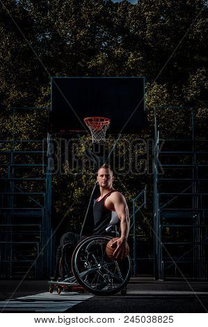 Portrait Of A Disabled Basketball Player In A Wheelchair On Open Gaming Ground.