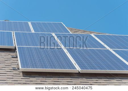 Solar Panel Installation On Asphalt Shingles Rooftop