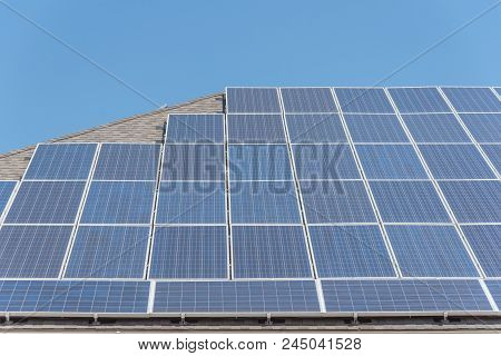 Solar Panel Installation On Asphalt Shingles Rooftop