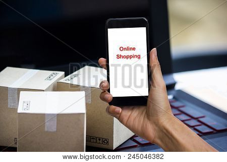 Online Shopping Concept E-commerce Delivery Buying Service. Square Cartons Shopping On Laptop Keyboa