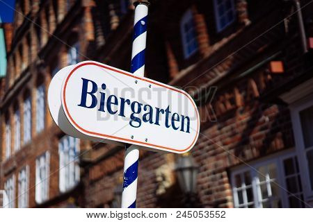 Beer Garden Sign. Opened Shield In German Biergarten On A Sunny Holiday. Old Traditional German Buil