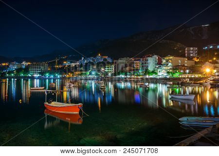Montenegro, Rafailovici - June 05/2017: Tourists Walk Along The Picturesque Night Embankment On The