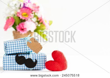 Happy Fathers Day Concept. Stack Of Beautiful Gift Box With Mustache And Paper Tag, Flower And Handm