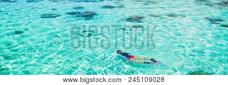 Vacation tourist snorkel woman swimming snorkeling in paradise clear water banner panorama. Swim girl snorkeler in crystalline waters and coral reefs. Turquoise ocean background.