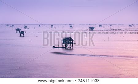 Sunrise Scene Of Bang Taboon Sea In Thai Gulf At Petchaburi, Thailand Where Fishermans Build Small S