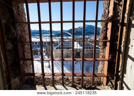 View Through Latticed Window Of Abandoned Prison In Kolyma