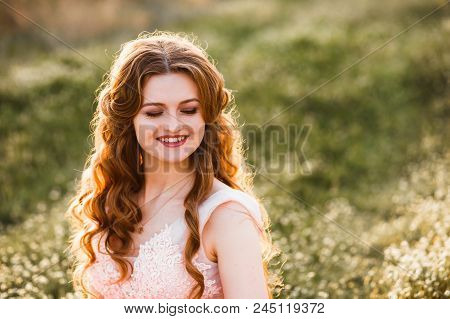 A Girl Is Walking Among The Blooming Peaches