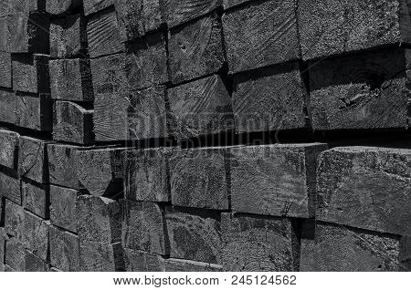 Set Of New Creosote Impregnated Wooden Sleepers Are Stacked On Each Other And Ready For Laying. Rail