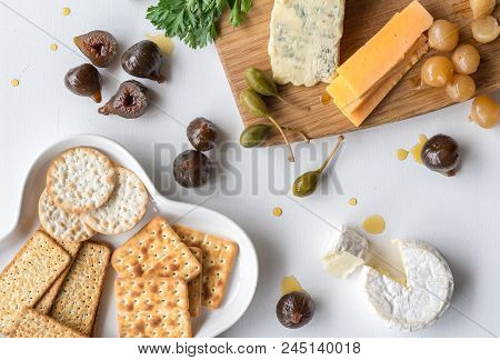 Cheese Board, With Blue Cheese, Camembert, Cheddar, Caperberries, Parsley And Glazed Figs With Plate