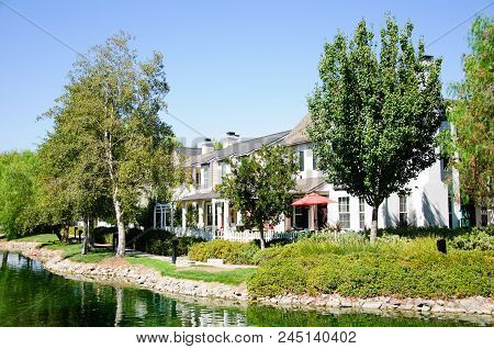 Beautiful House At Lake In Sunny Day, California