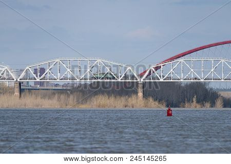 The Train Travels Along The Railway Bridge Across The River