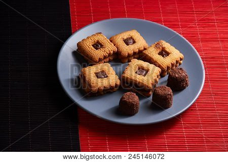 Warm Homemade Gingersnap Cookies Topped With Chocolate On Blue Plate