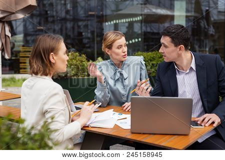 Business Proposal. Three Prosperous Managers Feeling Involved In Having Dispute About Upcoming Busin