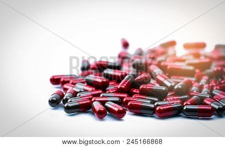 Pile Of Red And Grey Capsule Pills Isolated On White Background With Copy Space. Flunarizine : Drug 