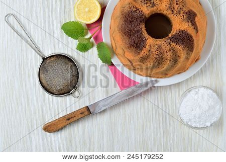 Top View Of Homemade Lemon Marble Cake, Milk, Eggs, Melissa Leaves, Still Life With Marble Cake On A