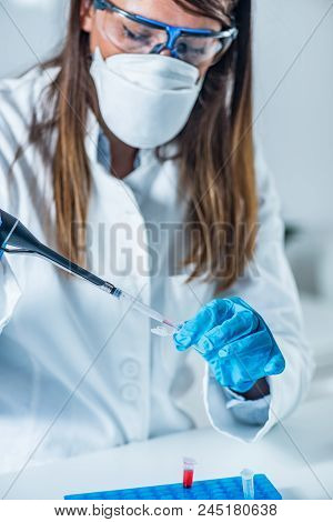 Forensic Science Expert Examining Evidence, Looking For Traces Of Dna