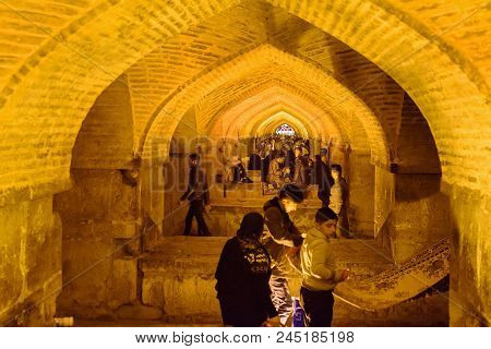 Isfahan, Iran - March 20, 2018: Iranian People Inside Khaju Bridge At Night In Spring