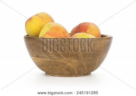 Yellow Peaches In A Wooden Bowl Isolated On White Background
