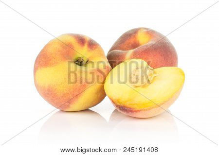 Two Ripe Yellow Peaches And One Sliced Half With A Drupe Isolated On White Background