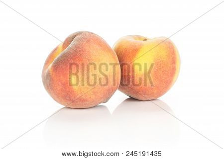 Two Ripe Yellow Peaches With A Red Blush Isolated On White Background