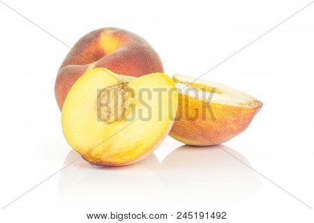 One Yellow Peach And Two Sliced Halves Isolated On White Background