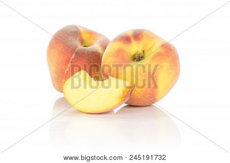 Two Yellow Peaches And One Slice Isolated On White Background