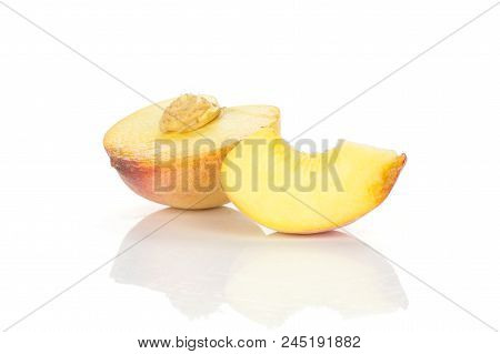 One Yellow Peach Half With A Slice And Drupe Inside Isolated On White Background