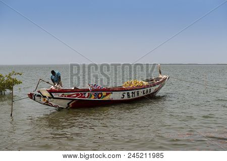 Cacheu, Republic Of Guinea-bissau - February 1, 2018: Fisherman Preparing His Canoe In The Port Of T