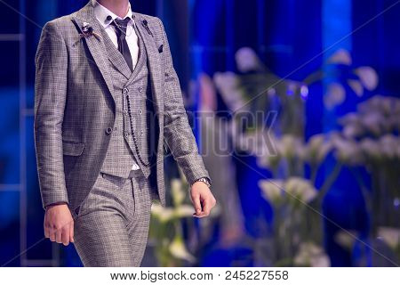 Sofia, Bulgaria - 28 March 2018: Male Model Walks The Runway In Grey Suit During A Fashion Show. Fas