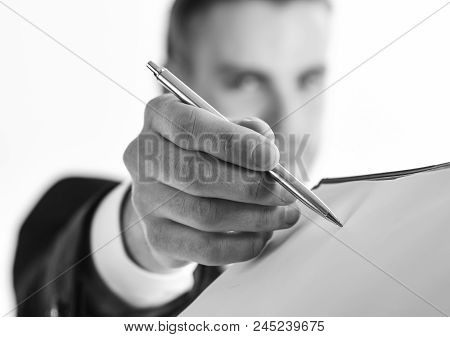 Businessman Signs Document By Pen On White Background. Signing Documents Concept. Man With Serious F